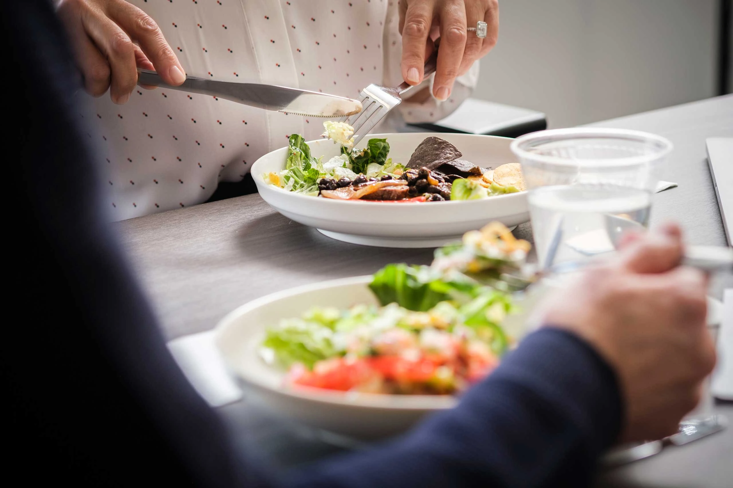 Close up shot of two salads on a table
